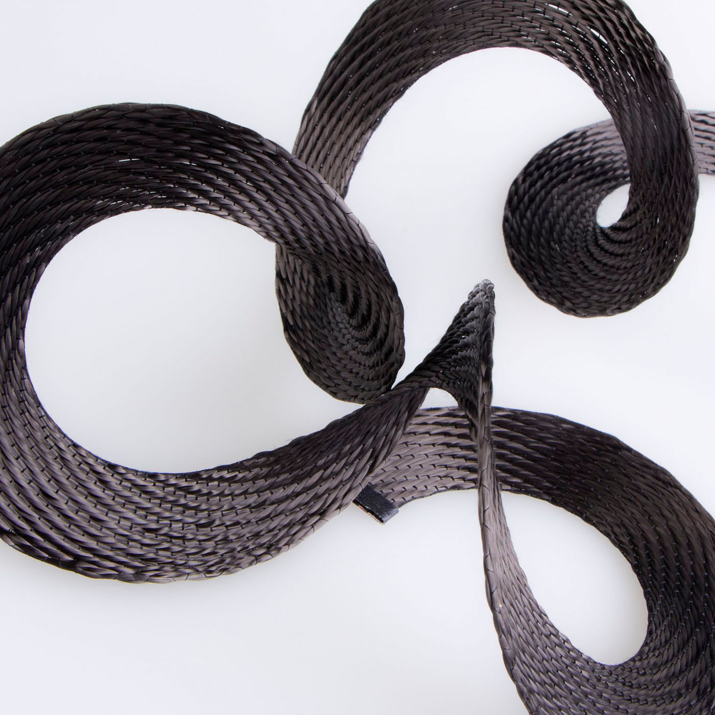 Composites made of spiral woven fabrics